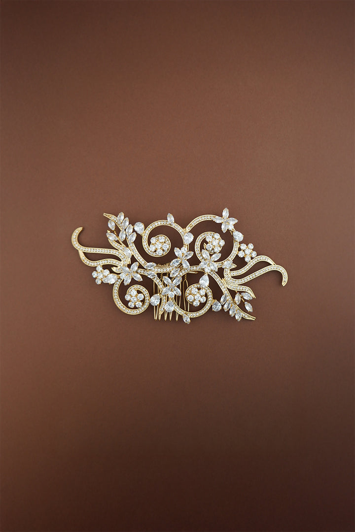 Decorative hair comb with floral and butterfly design on a brown background